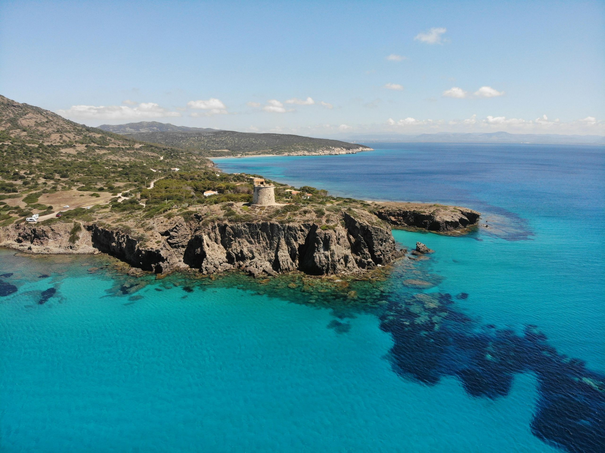 Stunning coastal view of Torre Cannai and crystal blue waters in Sardinia, Italy.