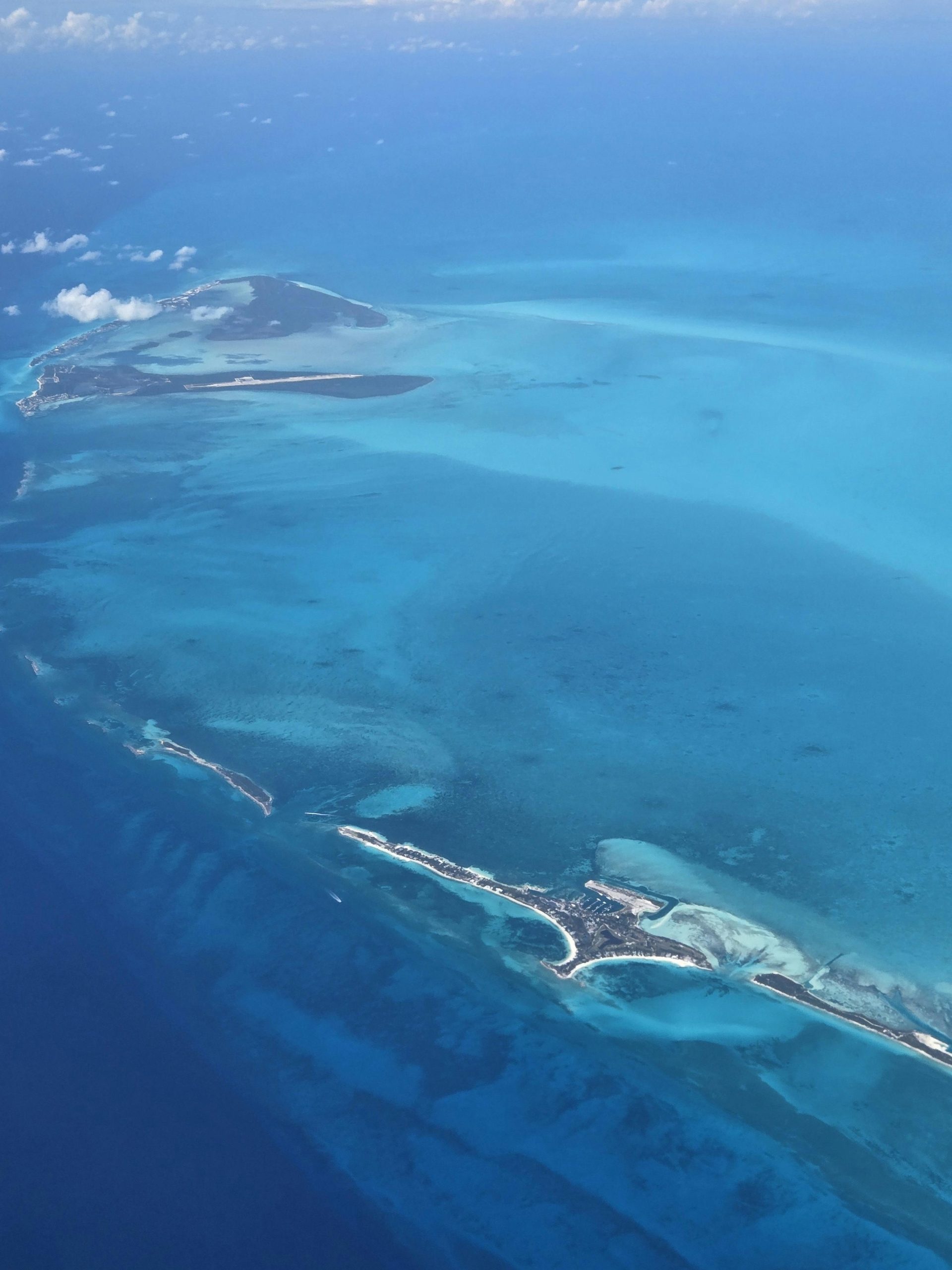 Stunning aerial view of the Bahamas' turquoise waters on a sunny day.