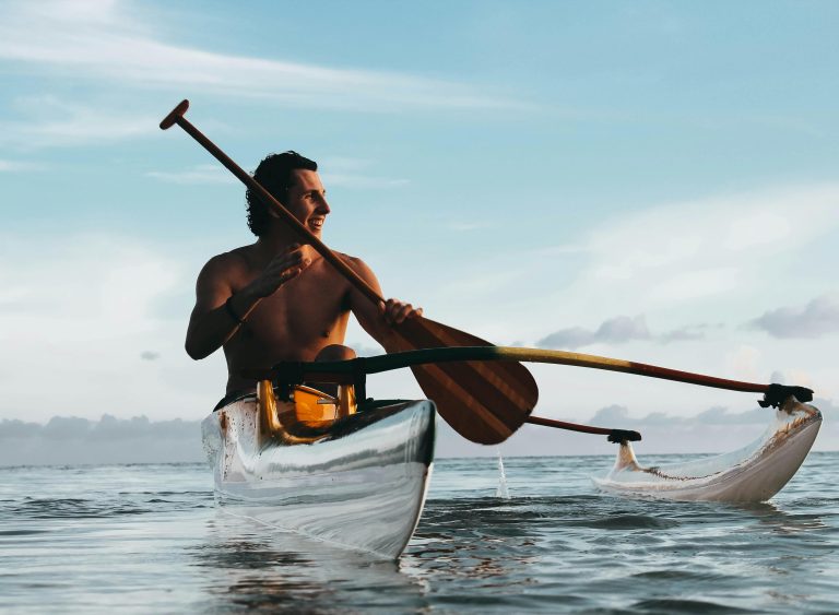 pexels-photo-1170807-1170807 A man enjoys canoeing on a serene ocean, surrounded by beautiful Polynesian scenery.